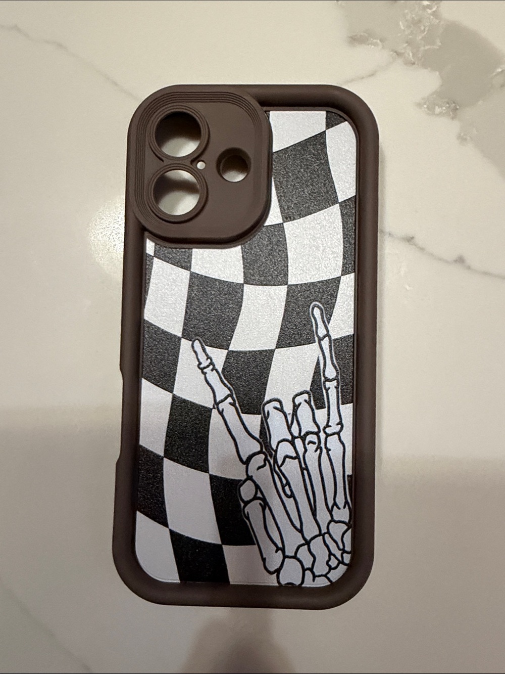 Brown Checkerboard Skeleton Hand iPhone 17 Case